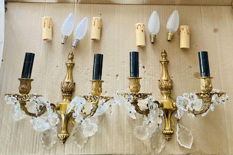 Pair of gilt bronze wall sconces with pendants from the mid-20th century.