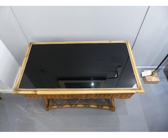 Wicker and black glass side table