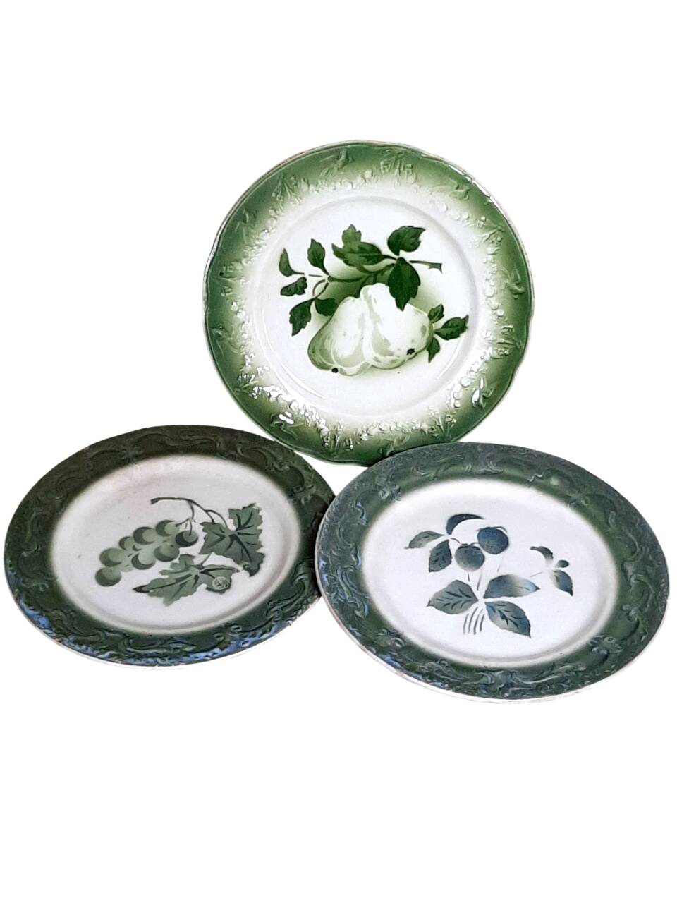 Antique earthenware plates with fruit decoration.
