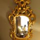 Carved and gilded wooden mirror with gold leaf 46 x 103 cm
