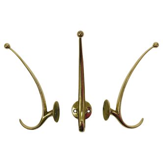 Two curved wall coat racks in brass by Franz Hagenauer, Vienna, mid-20th century, 1950s.