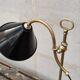 Old lamp in gilded bronze and brass with black enamel lampshade