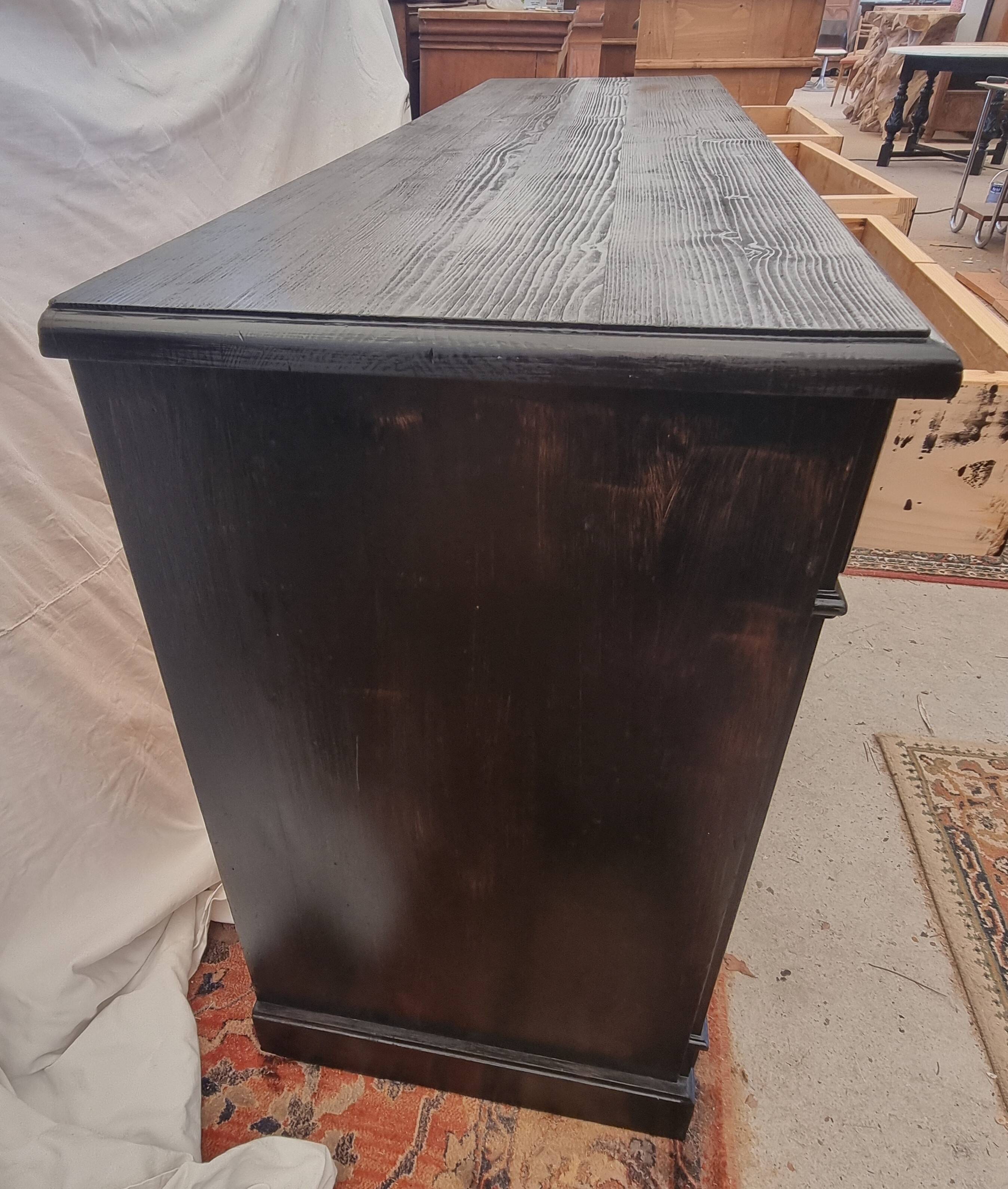 Black patinated chest of drawers