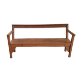 Church bench in fir tree with armrests