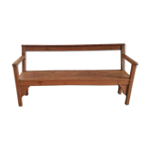 Church bench in fir tree with armrests