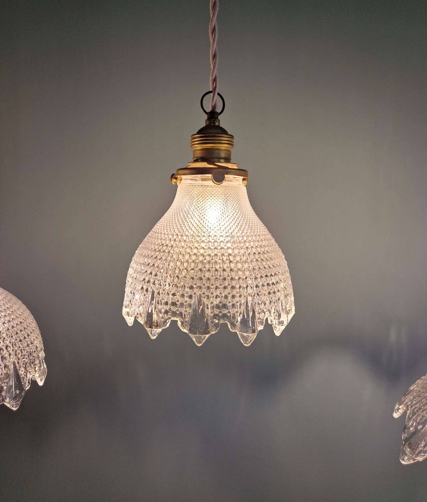 Trio of Art Deco scalloped clear glass pendant lights, 1920-30