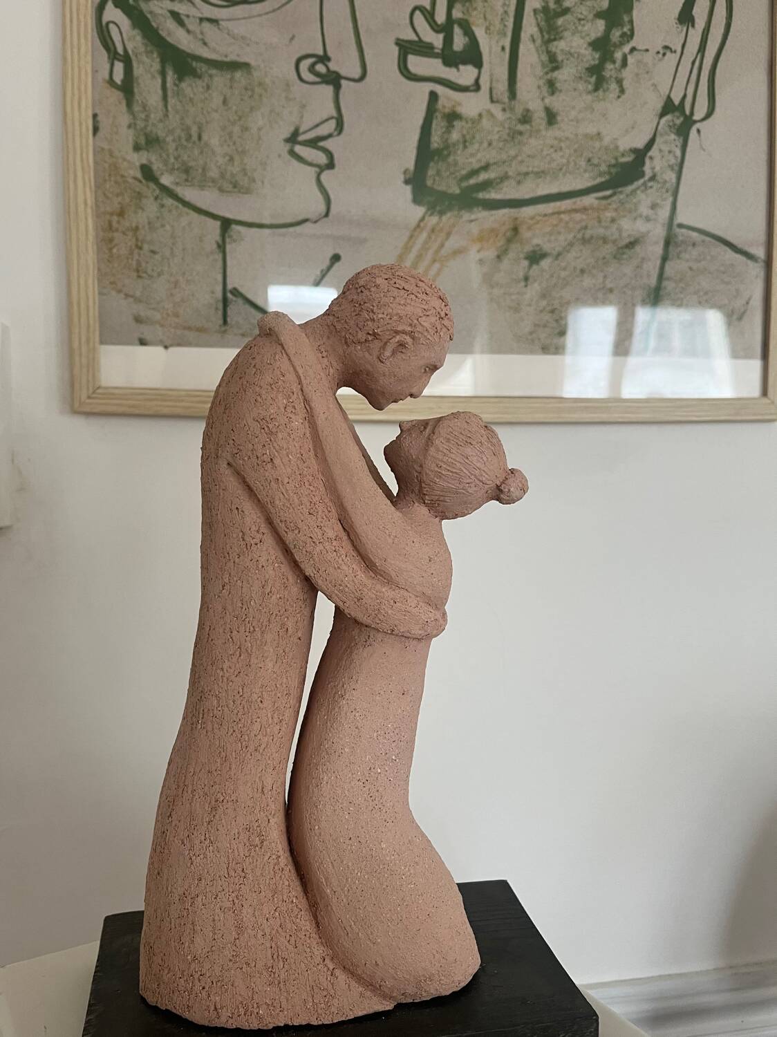 Sculpture of a couple entwined in grog clay.