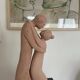 Sculpture of a couple entwined in grog clay.