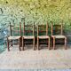 Set of 4 solid wood chairs with straw seats.