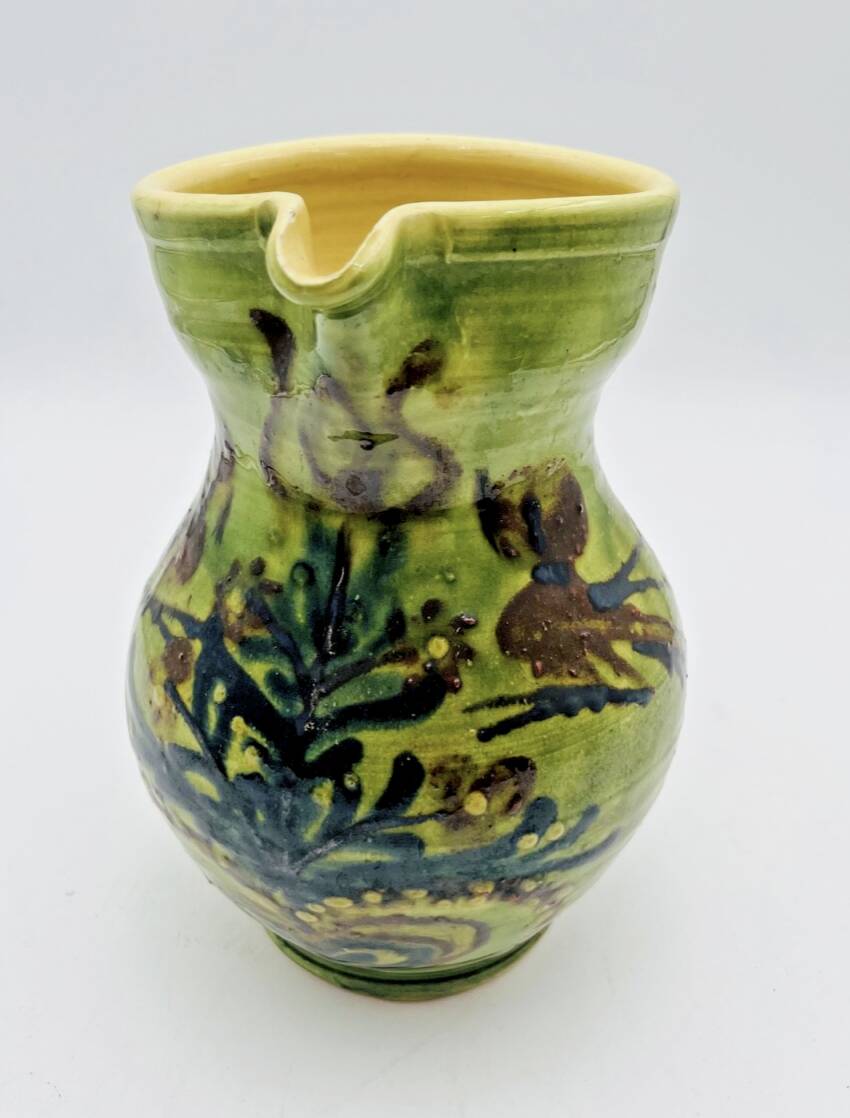 Green stoneware pitcher with flower and brown bird decoration