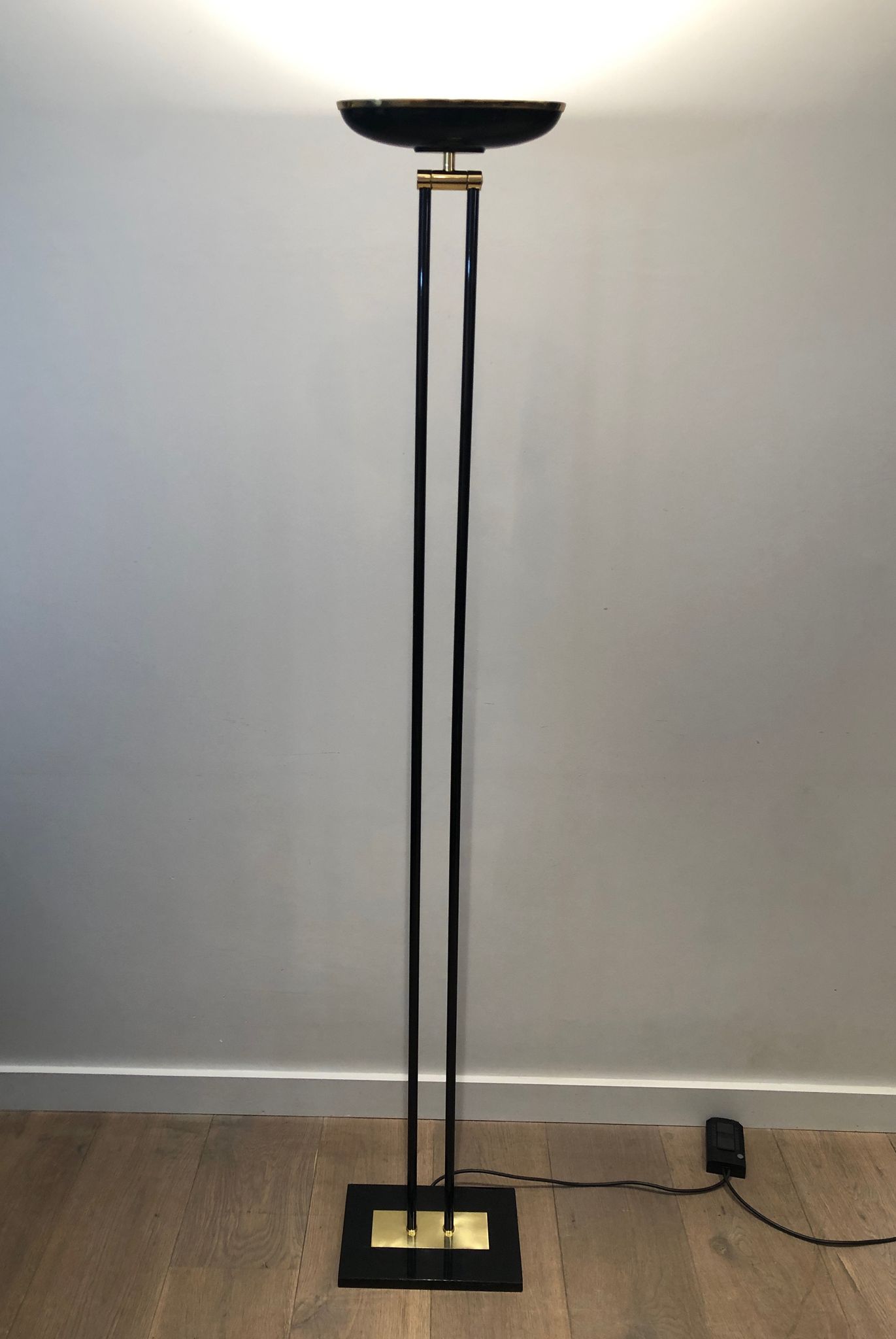 Black lacquered metal floor lamp with brass.