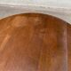 Round kitchen or dining table with extendable leaves in dark wood.