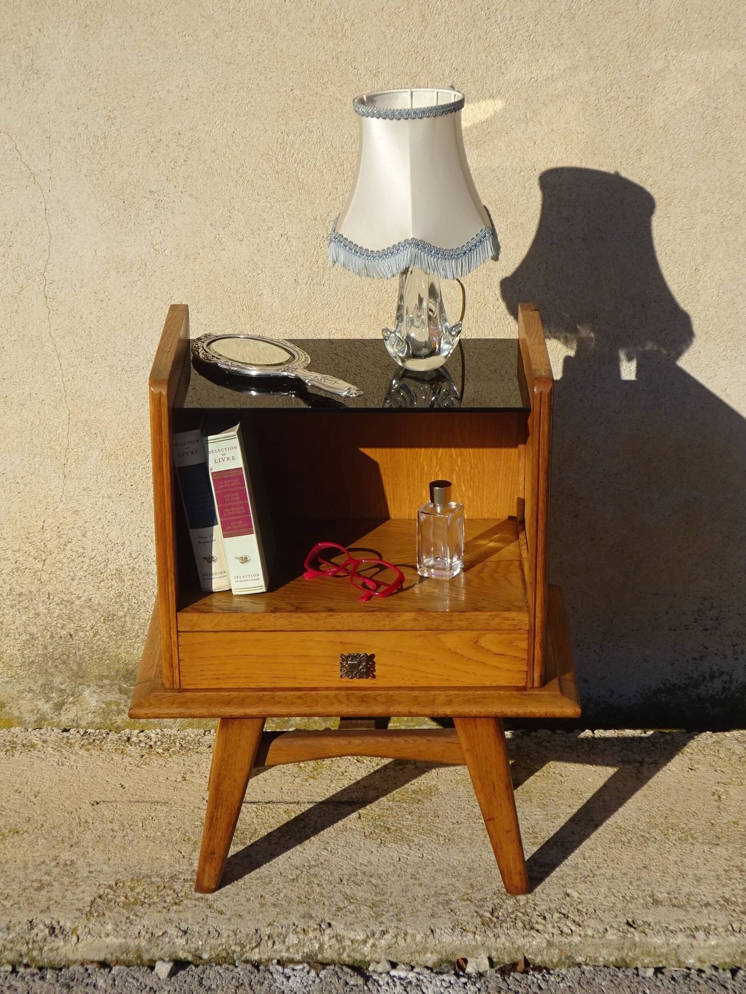 Vintage oak bedside table with tapered legs.
