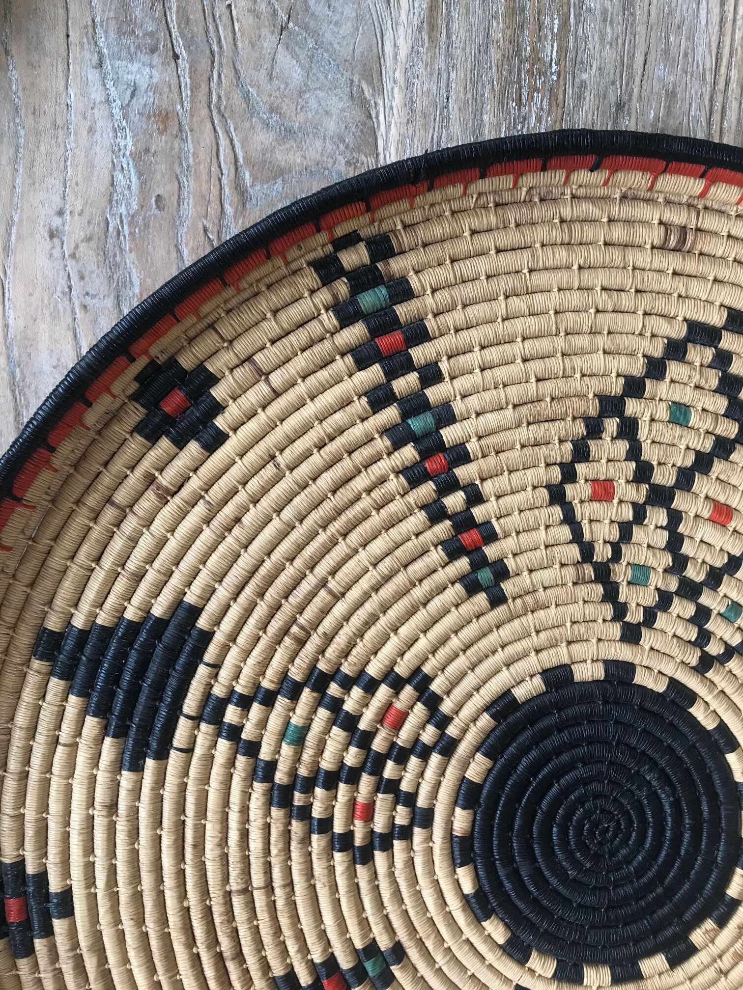 Braided wicker dish with ethnic motifs