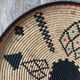 Braided wicker dish with ethnic motifs