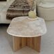 Oval coffee table in travertine and raw oak.