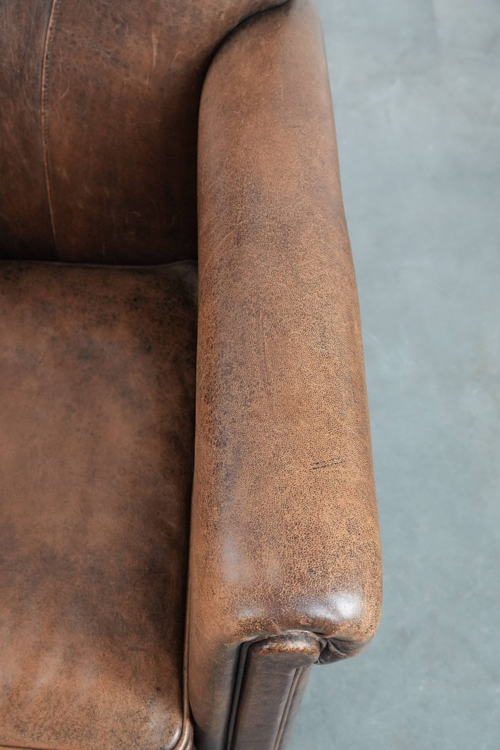 Vintage sheepskin armchair with warm colours and a characterful appearance