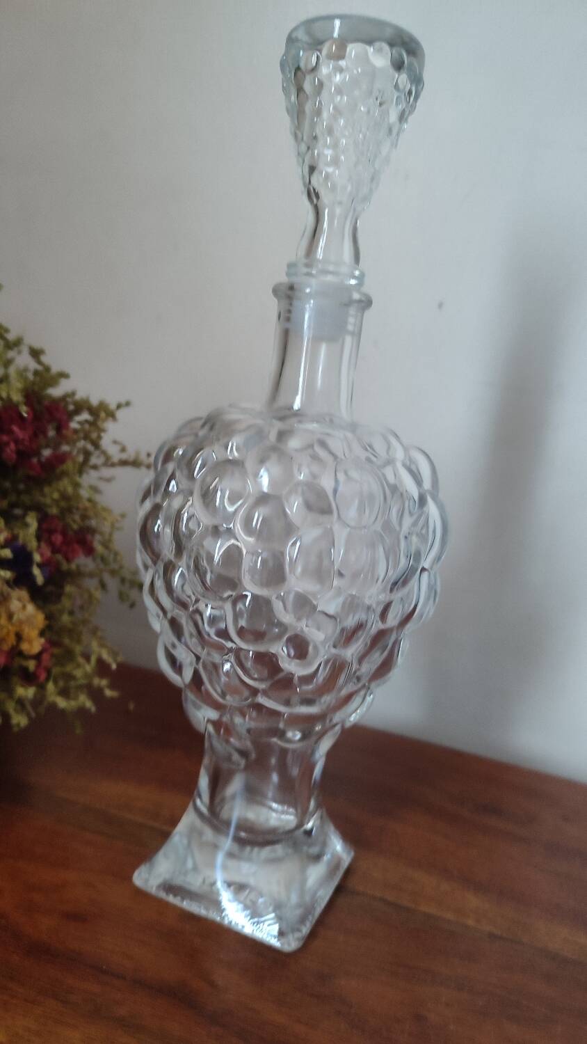 Pressed glass carafe in the shape of a bunch of grapes.