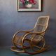 Vintage rocking chair in rattan from the 60s-70s, high openwork backrest.