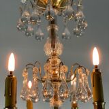 Gilded bronze chandelier trimmed with drop-shaped stamps