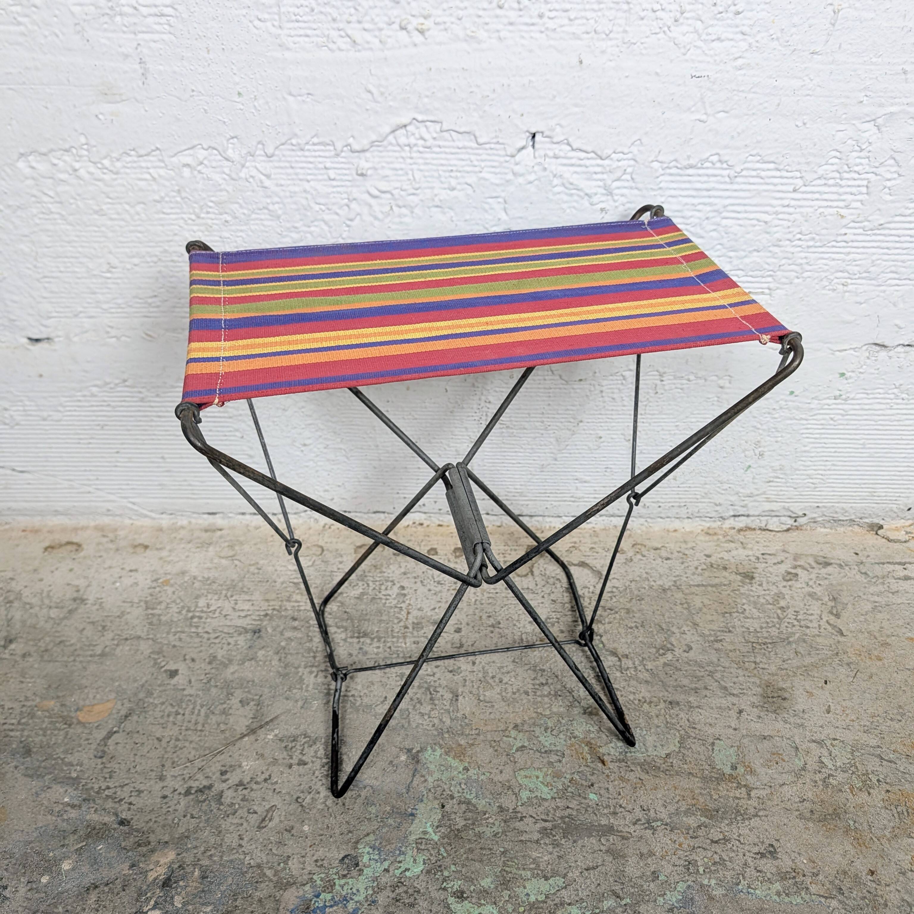 Vintage folding stool with a bayadère fabric pattern.