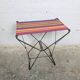 Vintage folding stool with a bayadère fabric pattern.