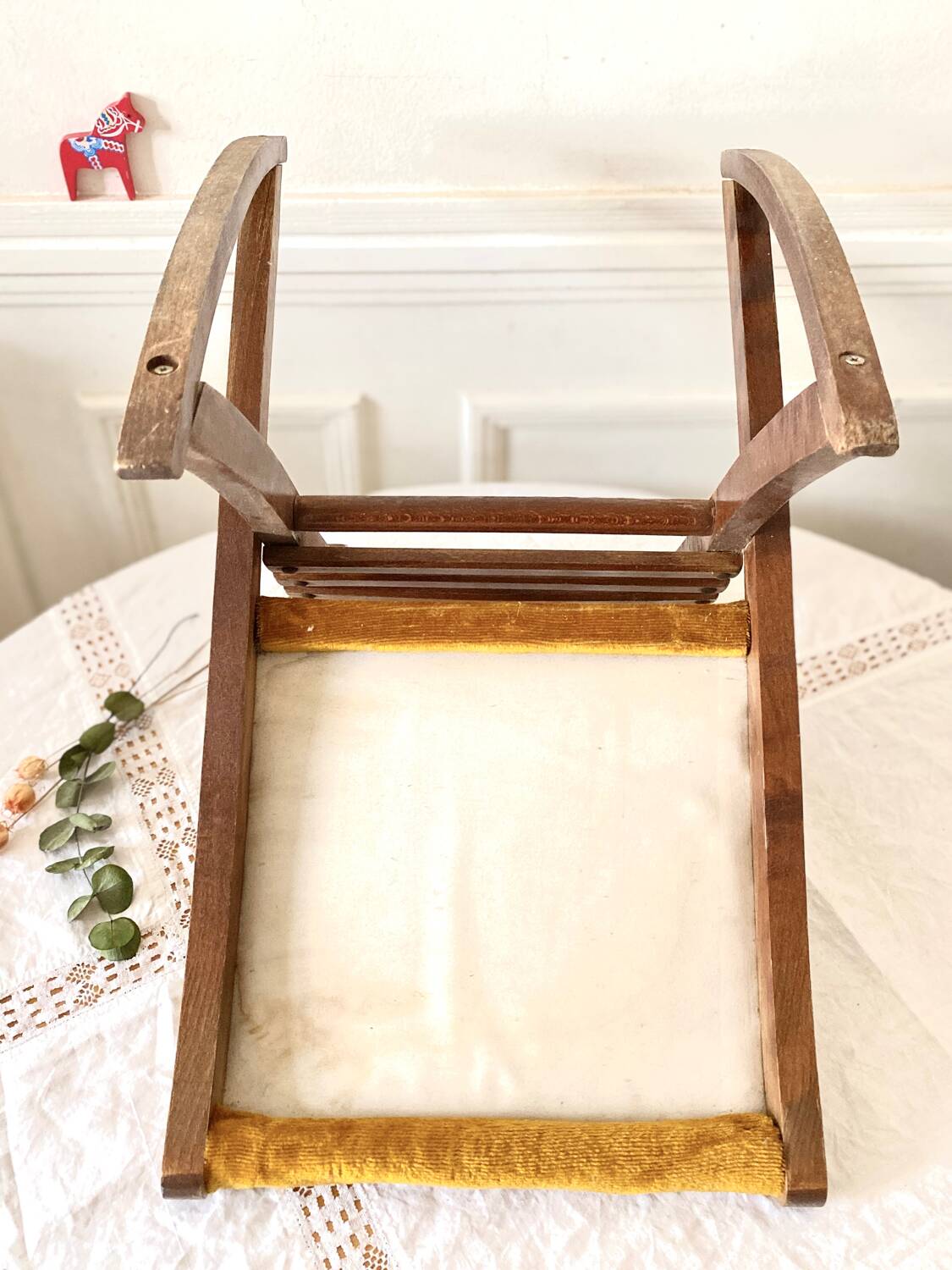 Old wooden rocking footrest with velvet fabric