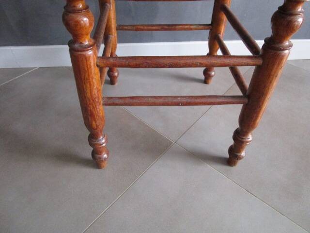Antique wooden stool with cane seat.