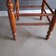 Antique wooden stool with cane seat.