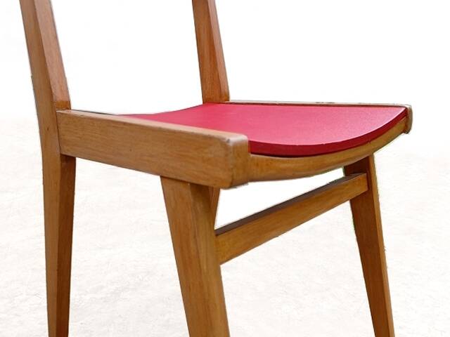 Vintage chairs from the 1950s in wood and faux leather.