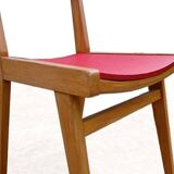 Vintage chairs from the 1950s in wood and faux leather.