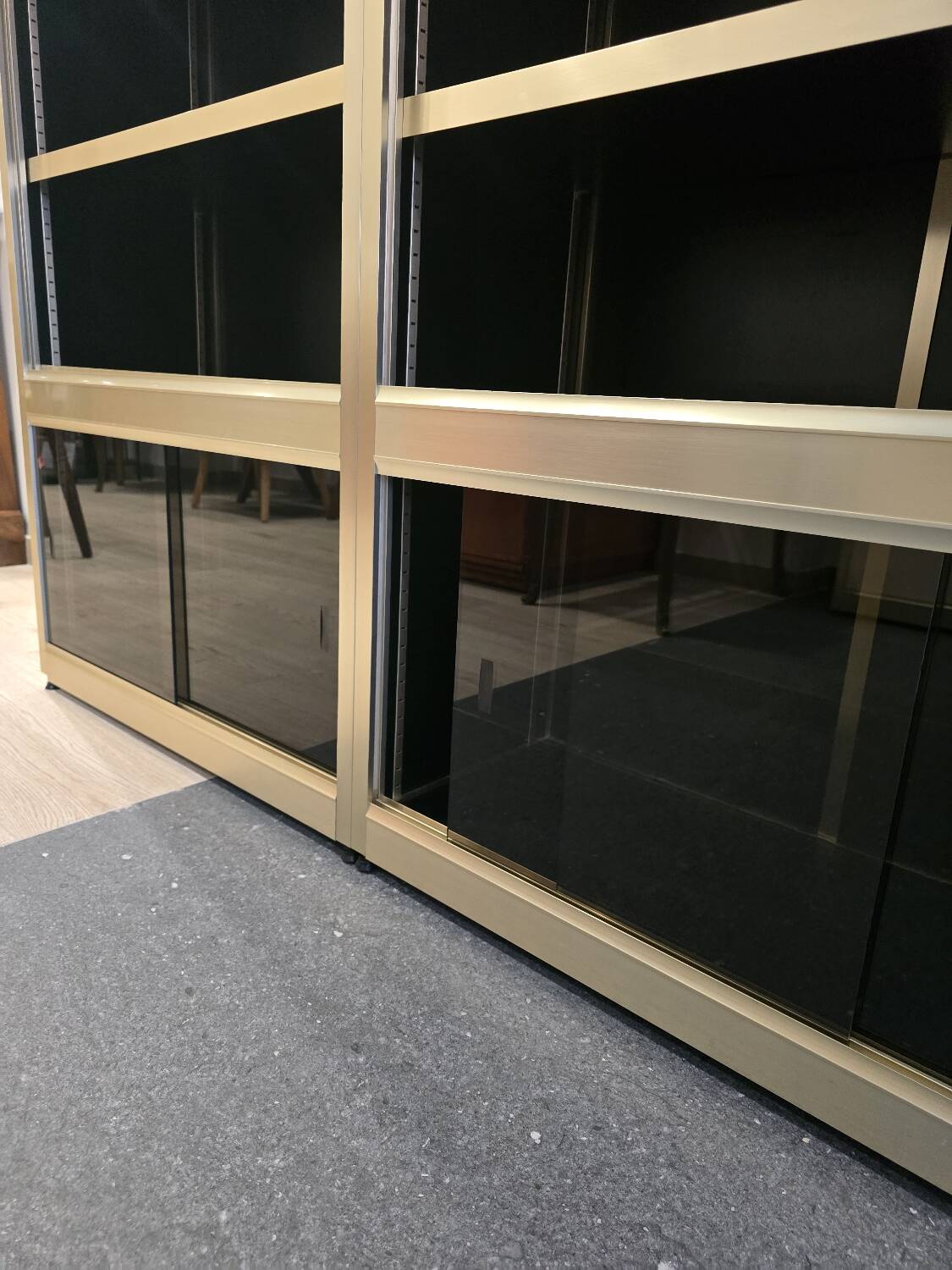 1970s design library with gold metal and lacquered wood.