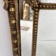 Louis XVI style mirror with parecloses in wood and gilded stucco, 19th century