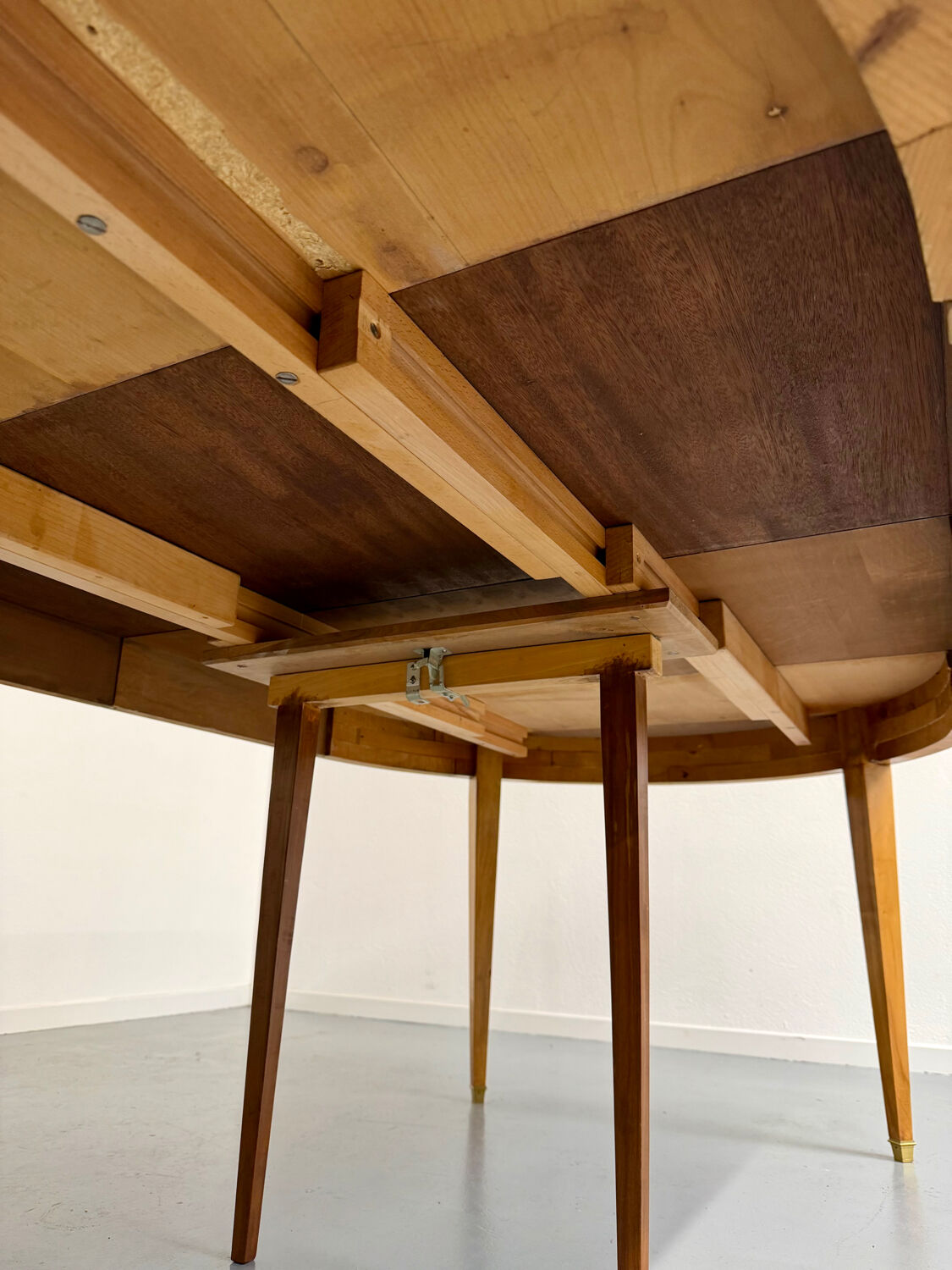 Round walnut Napoleon III extendable table with bronze top in good condition.