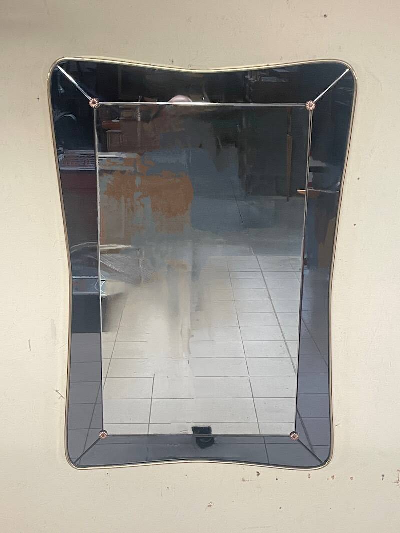1950s double-thickness wall mirror with brass profile and supports.