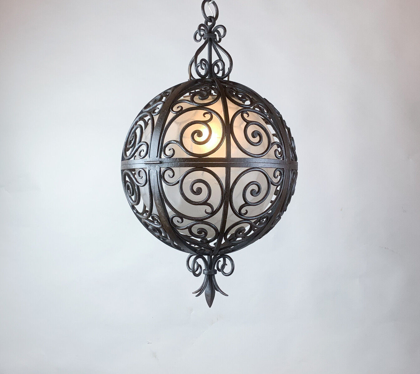 Wrought iron round suspension with interior glass sphere, c.1930