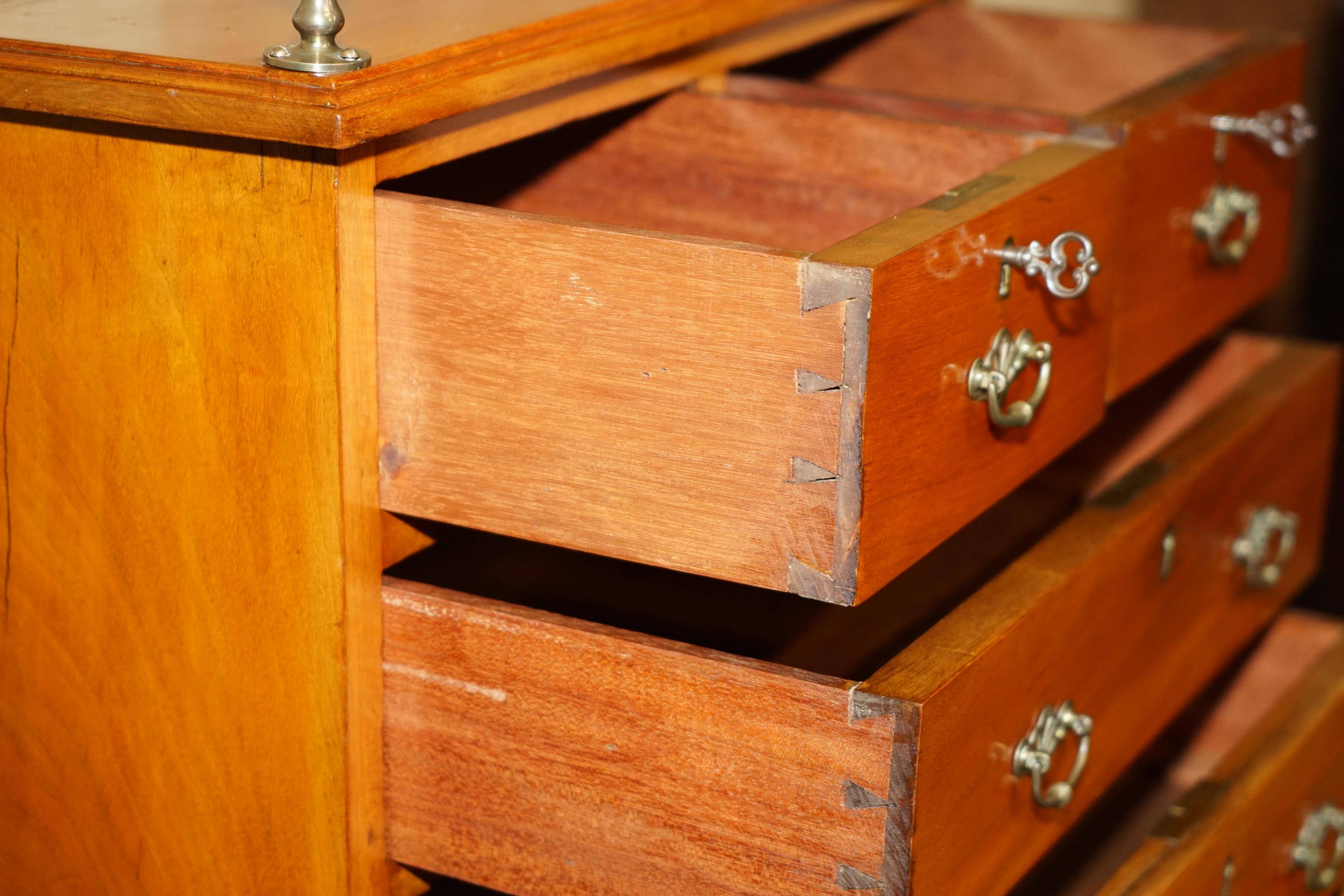 Victorian high chest of drawers in walnut with a bronze gallery.