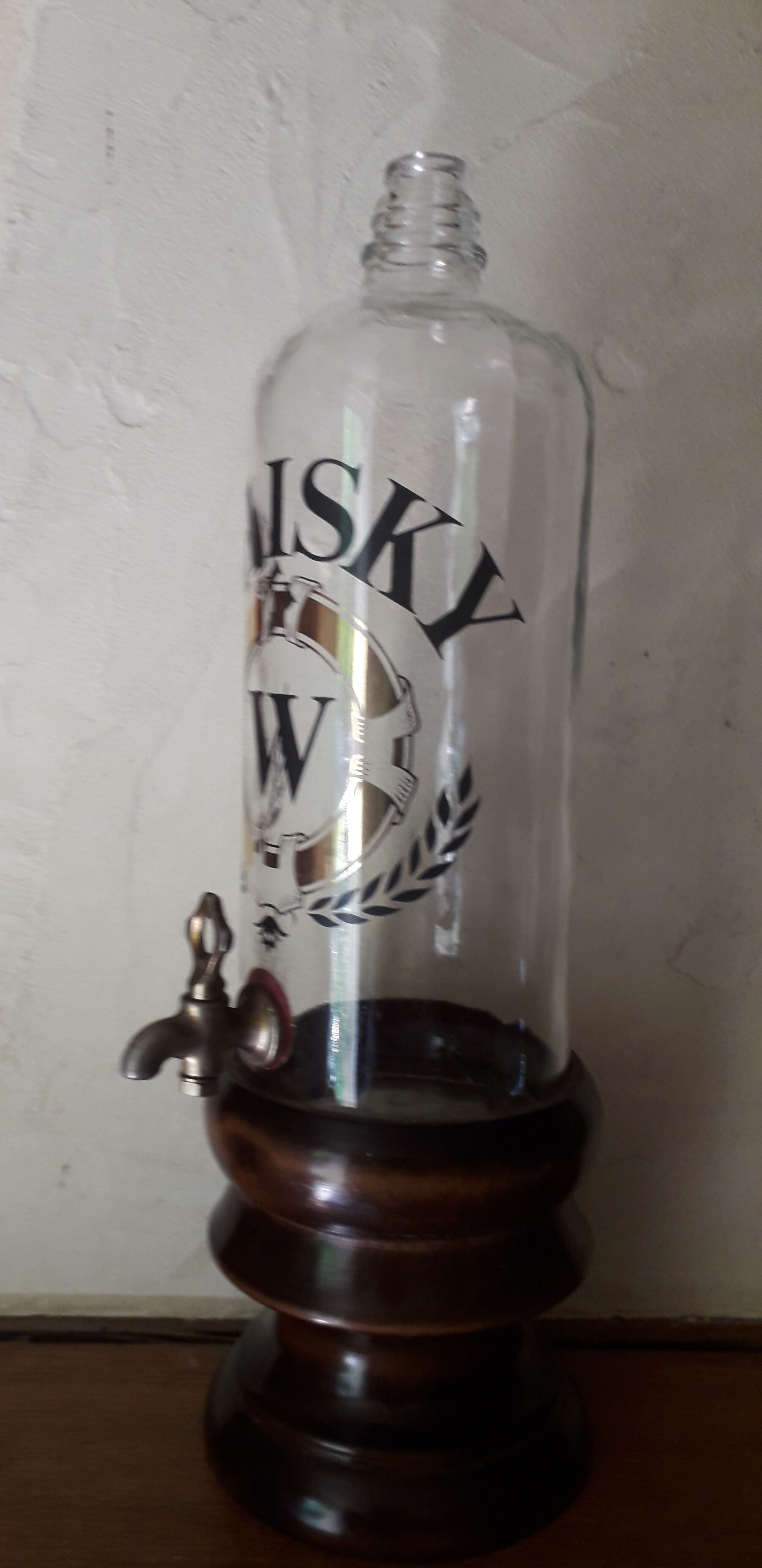 Vintage glass and wood whiskey bottle with pouring tap