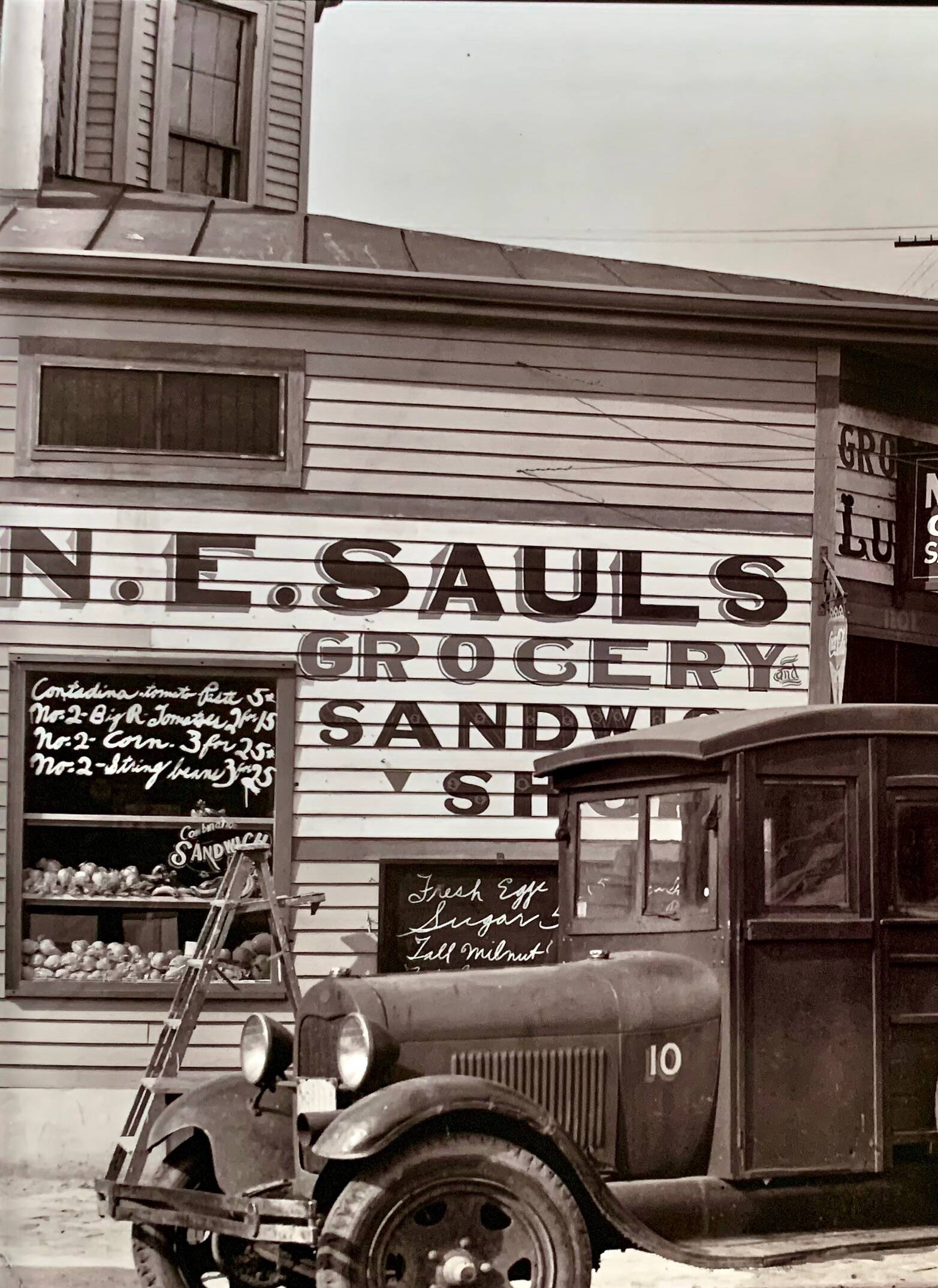 "Street corner in New Orleans, front of the NE Saul' sandwich shop