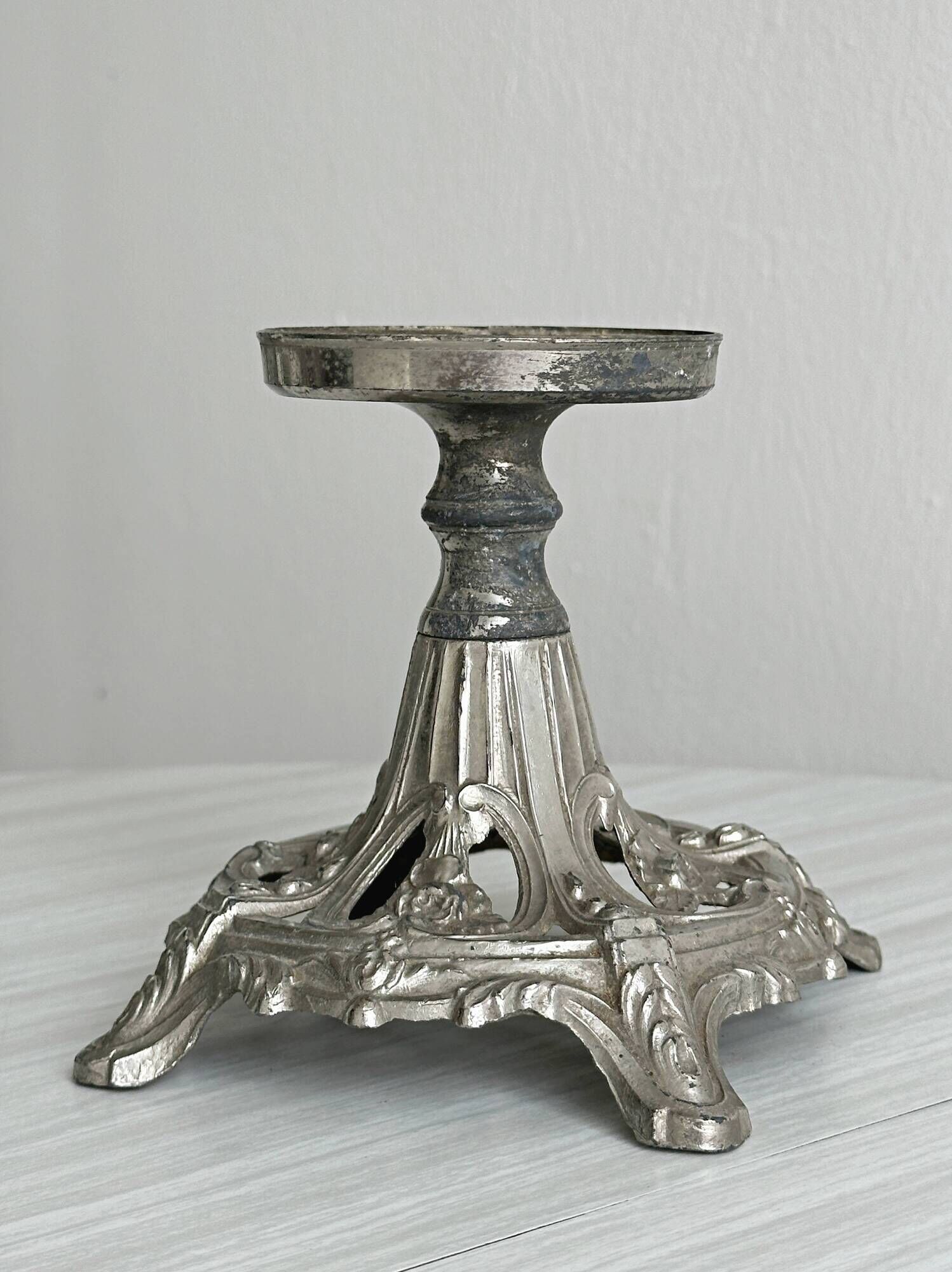 Candle holder with sculpted metal base, antique.