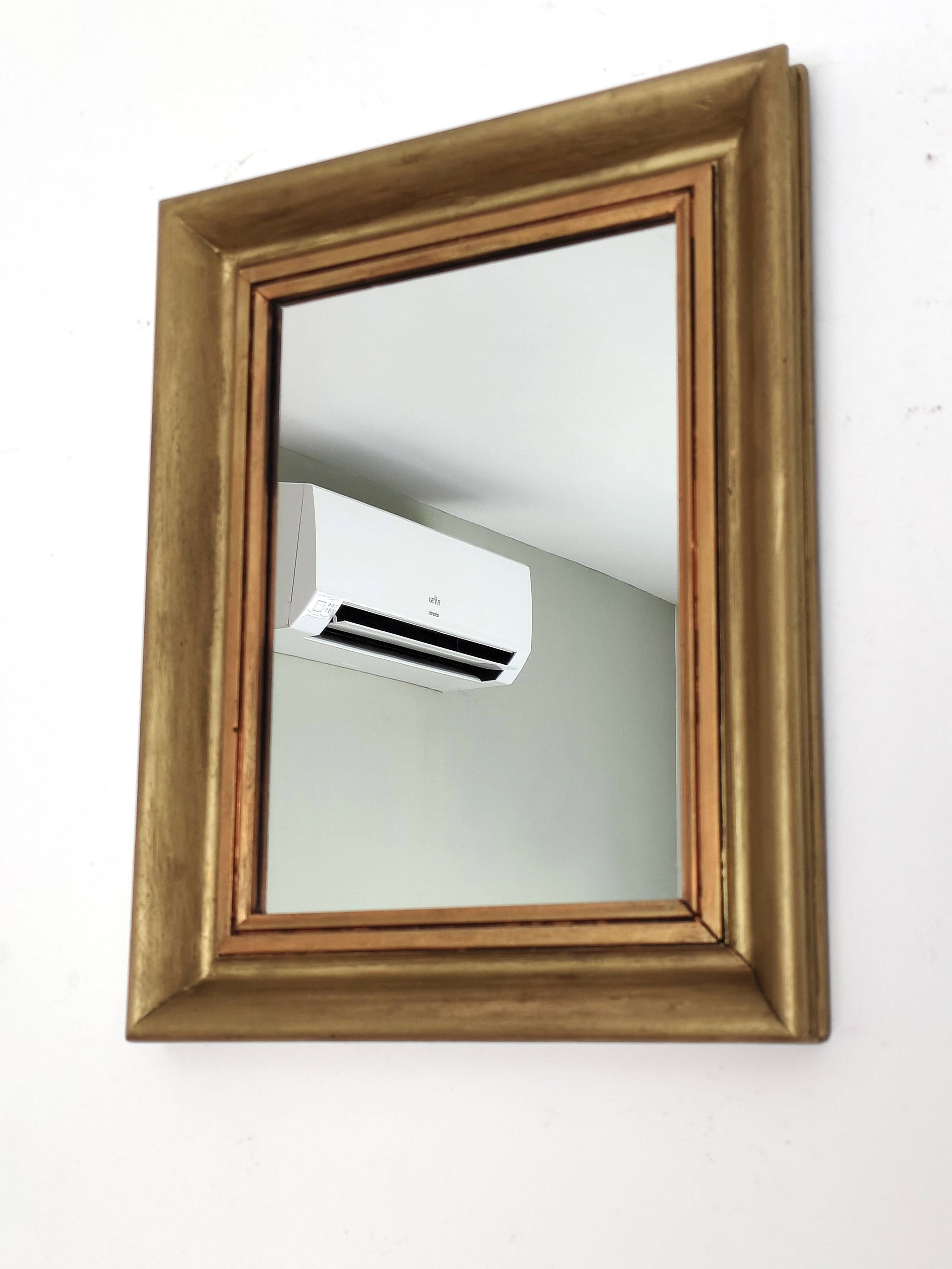 Antique mirror in gilded and copper wood