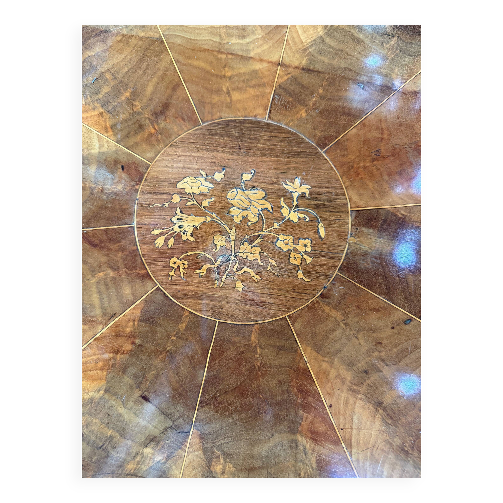 Antique round table with floral details.