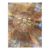 Antique round table with floral details.