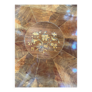 Antique round table with floral details.
