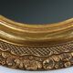 French Baroque style oval mirror in gilded wood with floral decorations