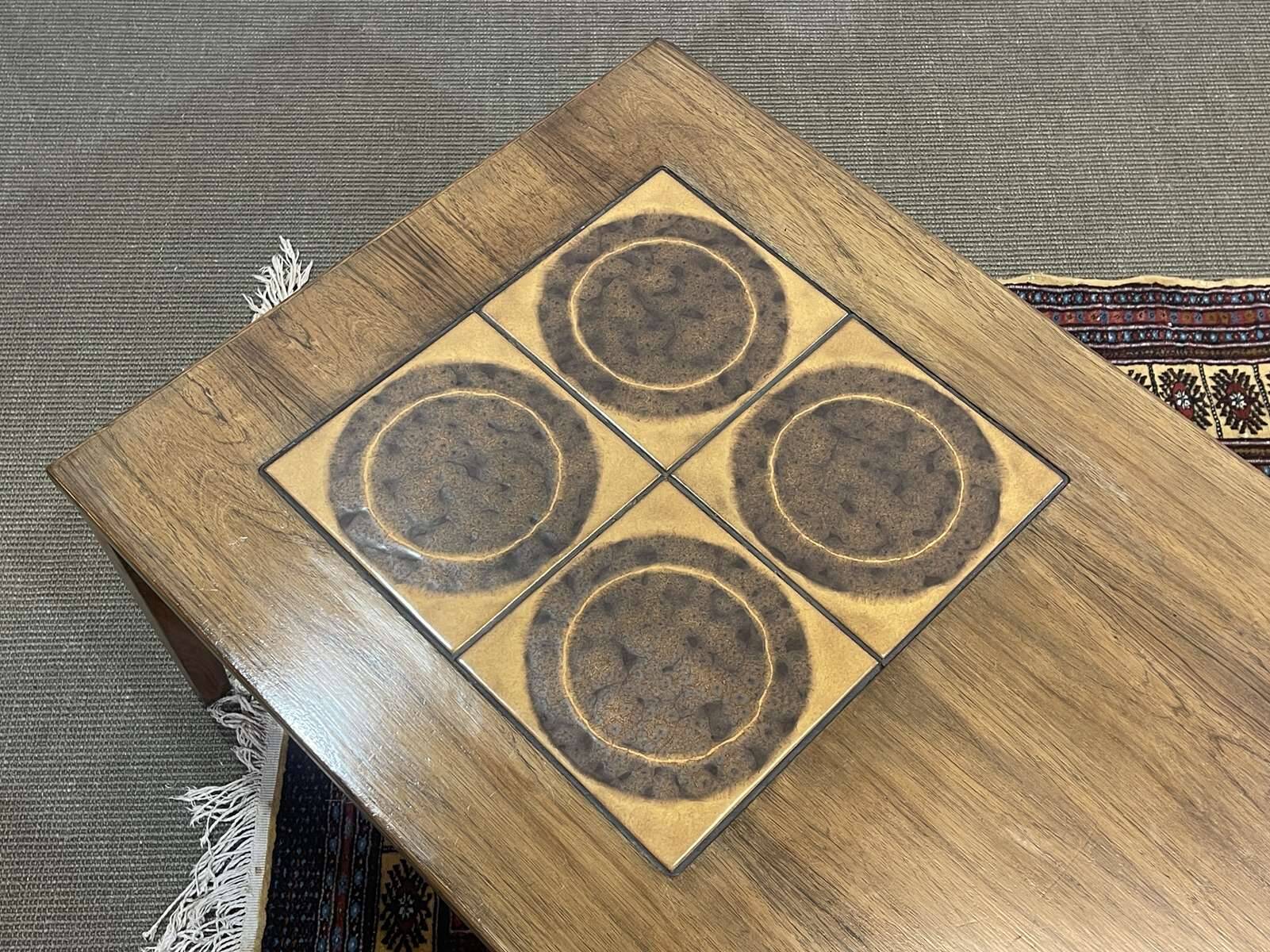 English coffee table in rosewood with tiled section from the 1970s.