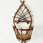 Wall-mounted plant holder in rattan