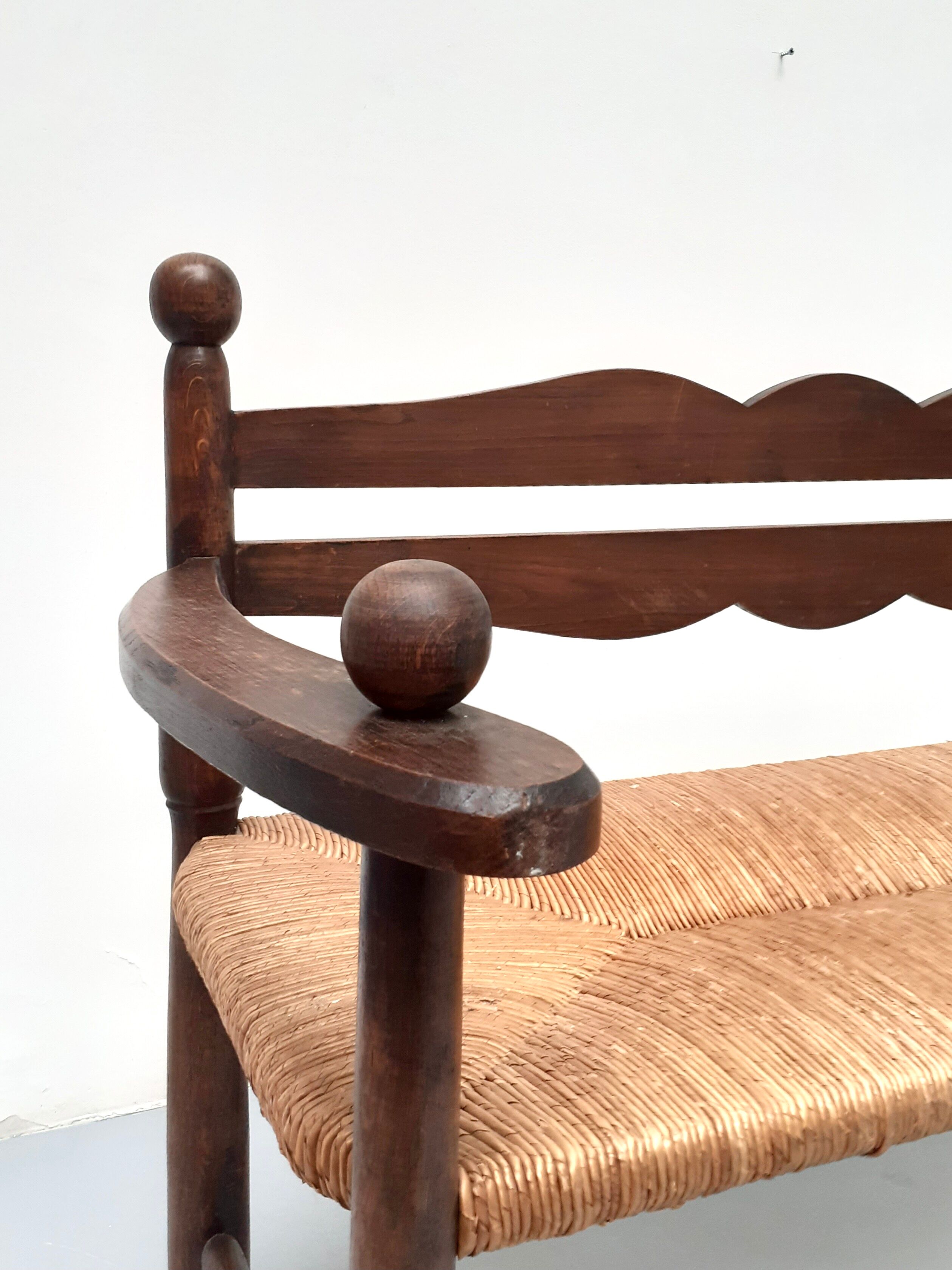 Vintage bench with wooden backrest and structure and mulched seat