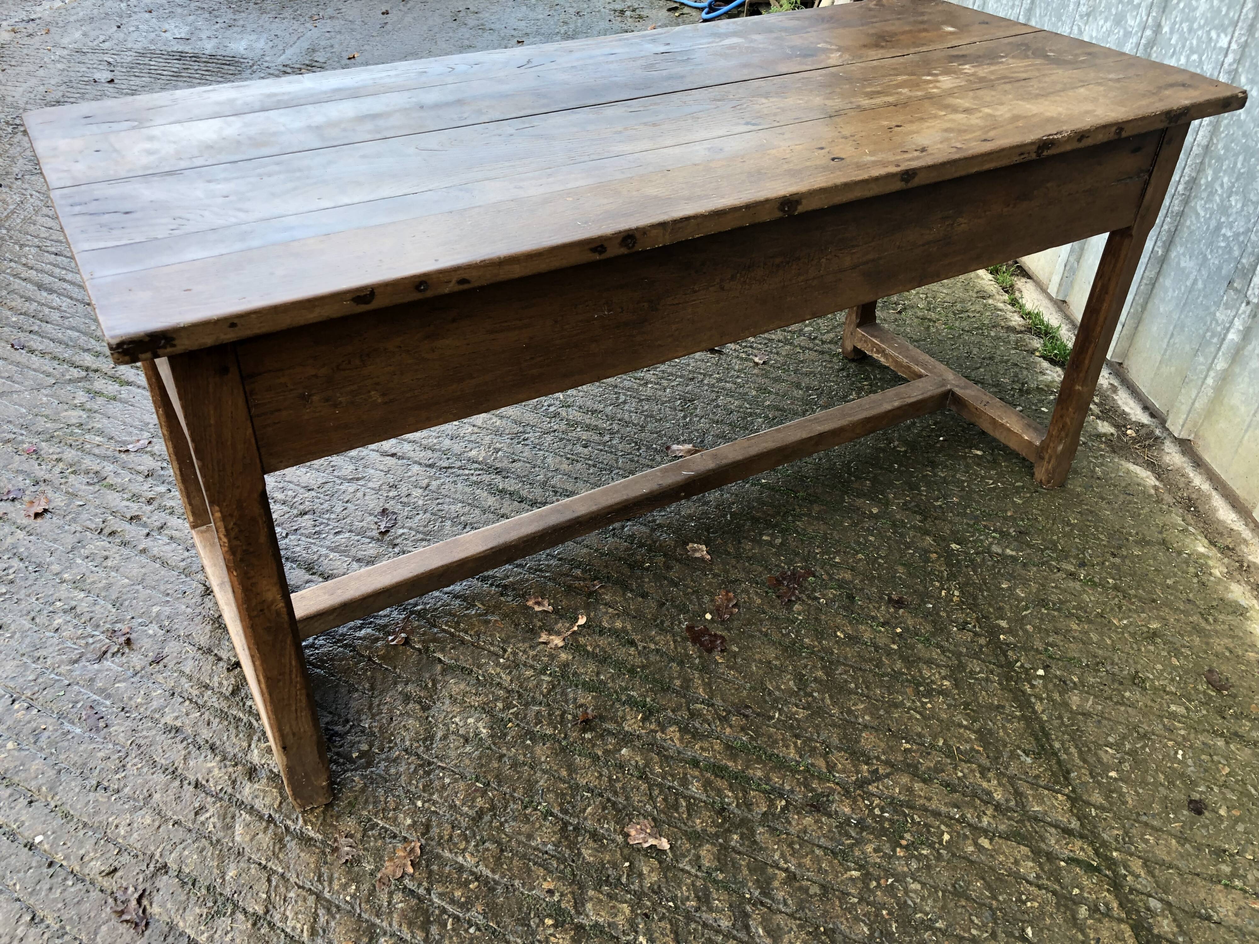 Old chestnut table with 3 front drawers and a cat bar.