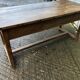 Old chestnut table with 3 front drawers and a cat bar.
